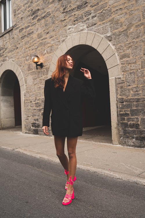 A Woman in Black Blazer and Pink Heels Standing on Street