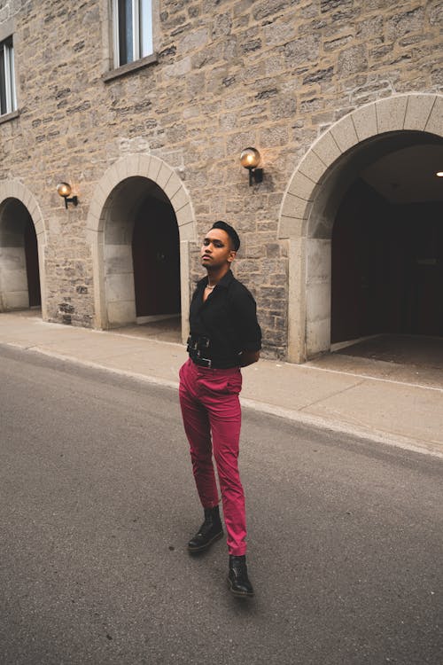 Man Wearing Black Shirt and Pink Trousers on a Street 