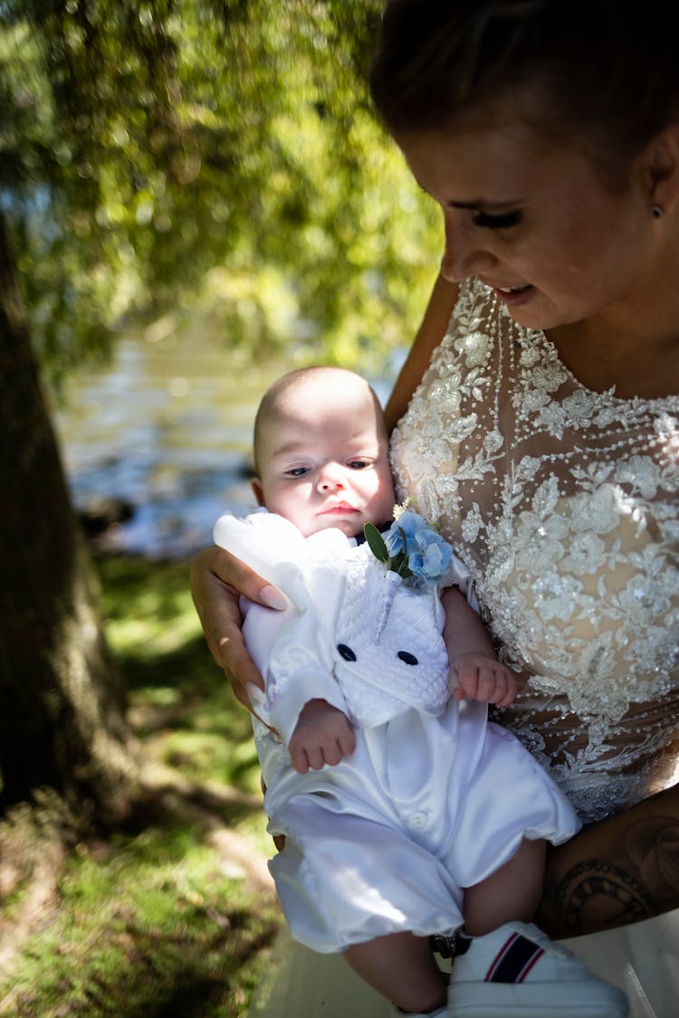 Bride Holding A Newborn Baby 