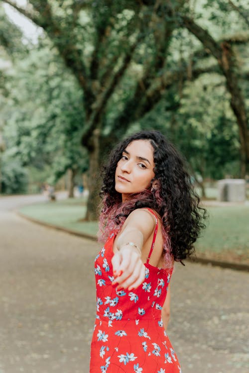 A Woman Wearing Red Floral Dress 