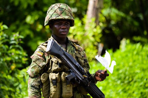 Soldier with Machine Gun and Paper Bird in Jungle