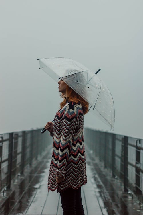 Woman Under an Umbrella on a Pier