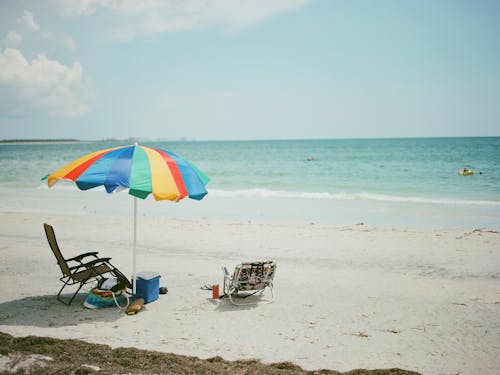 Lounge Chairs and Beach Umbrella on the Sandy Shore