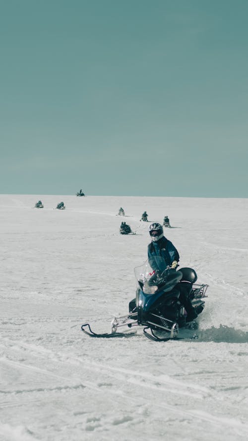Tourists Riding on a Snowmobile