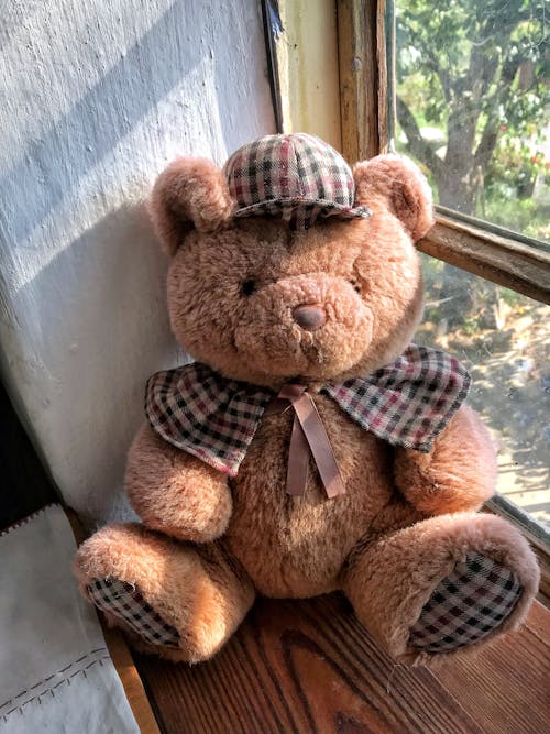 Free A Teddy Bear by a Windowsill Stock Photo