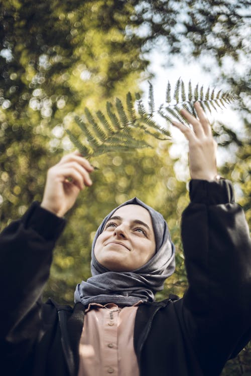 Woman Holding Fern Leaf