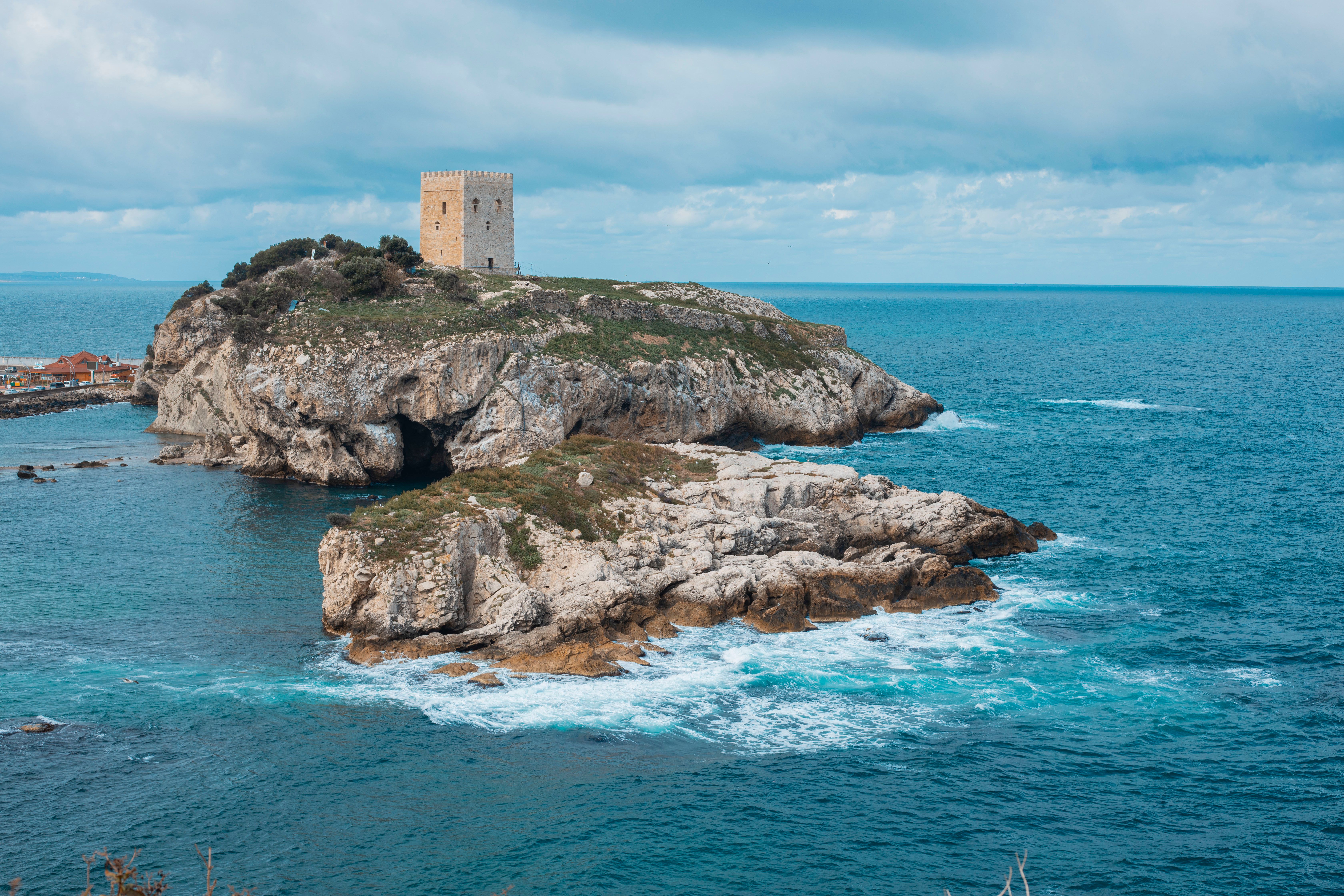 Brown Castle on an Island in the Middle of the Sea · Free Stock Photo