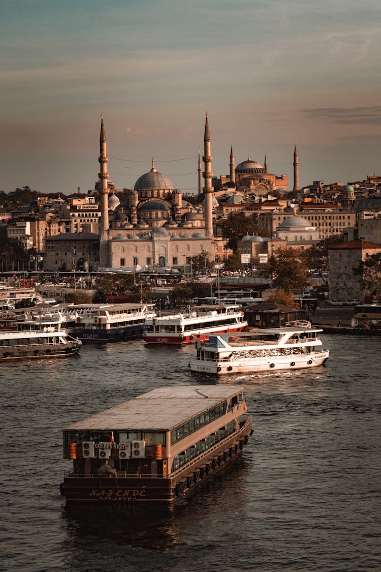 Ferries Sailing On The River Near City Buildings