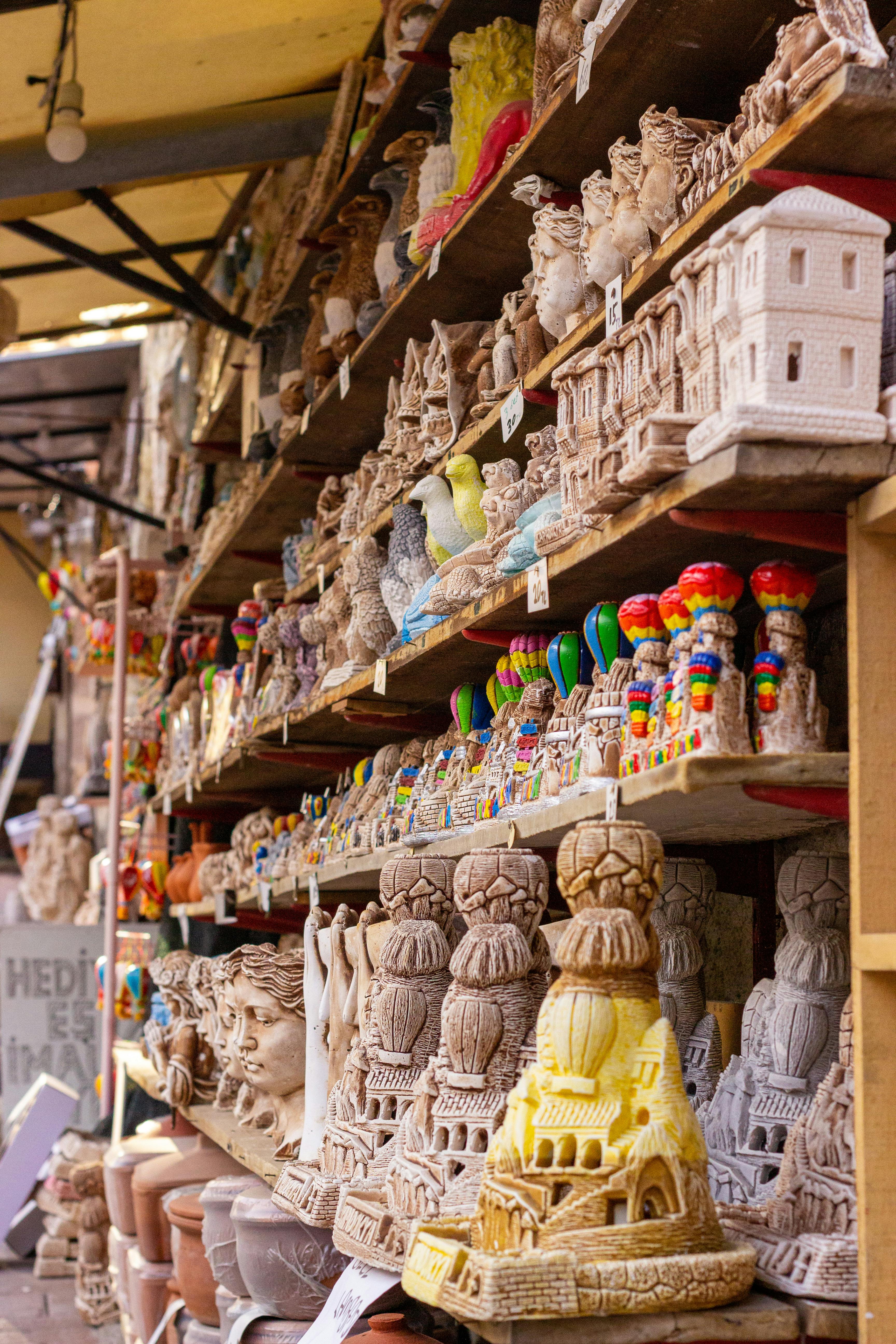 Assorted Souvenirs Displayed on Wooden Rack · Free Stock Photo