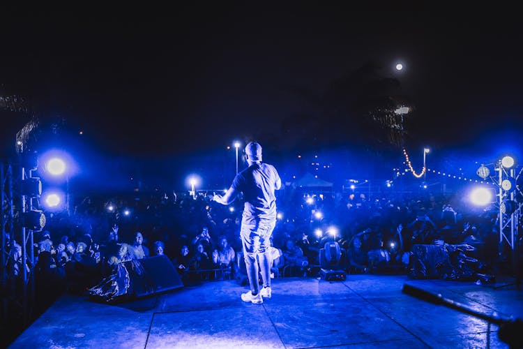 A Man Performing On A Stage