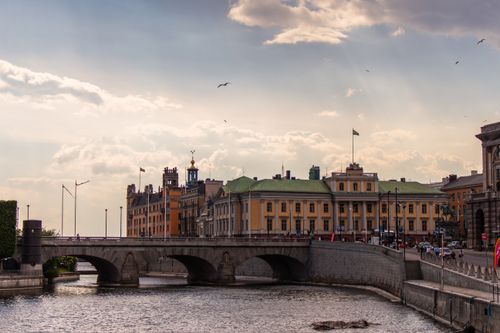 Experience the charm of Stockholm with this picturesque view of historic buildings and a bridge.
