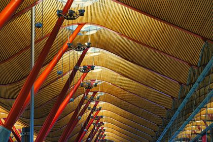 Geometric terminal ceiling with rows of coloured columns. Photo by Ramon Perucho on Pexels