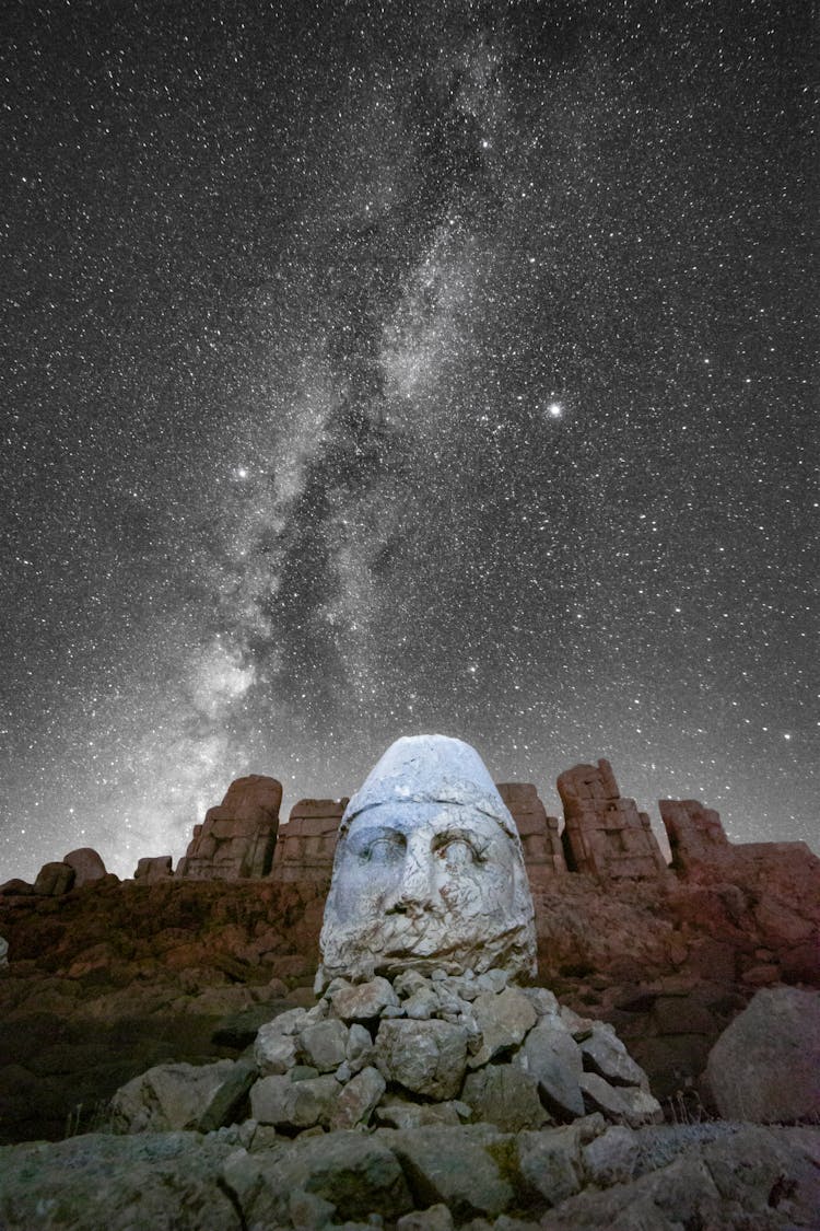 Ancient Stone Sculpture Under Starry Sky