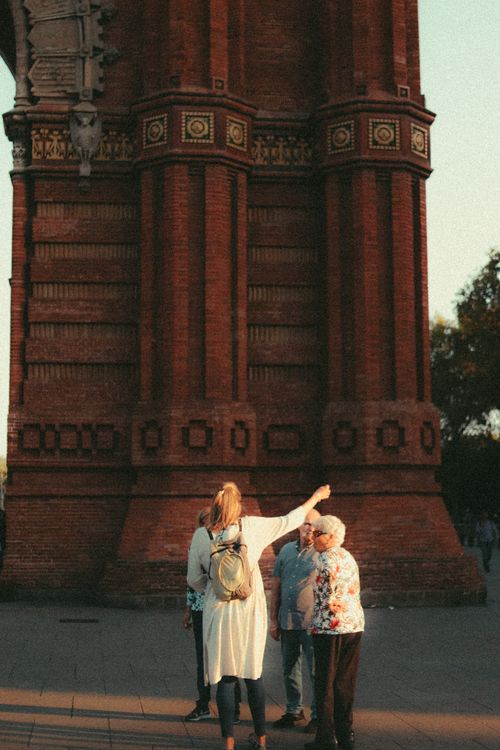 Free Elderly group exploring a brick architectural site at sunset. Stock Photo