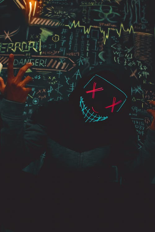 Man Wearing Creepy Halloween Neon Mask