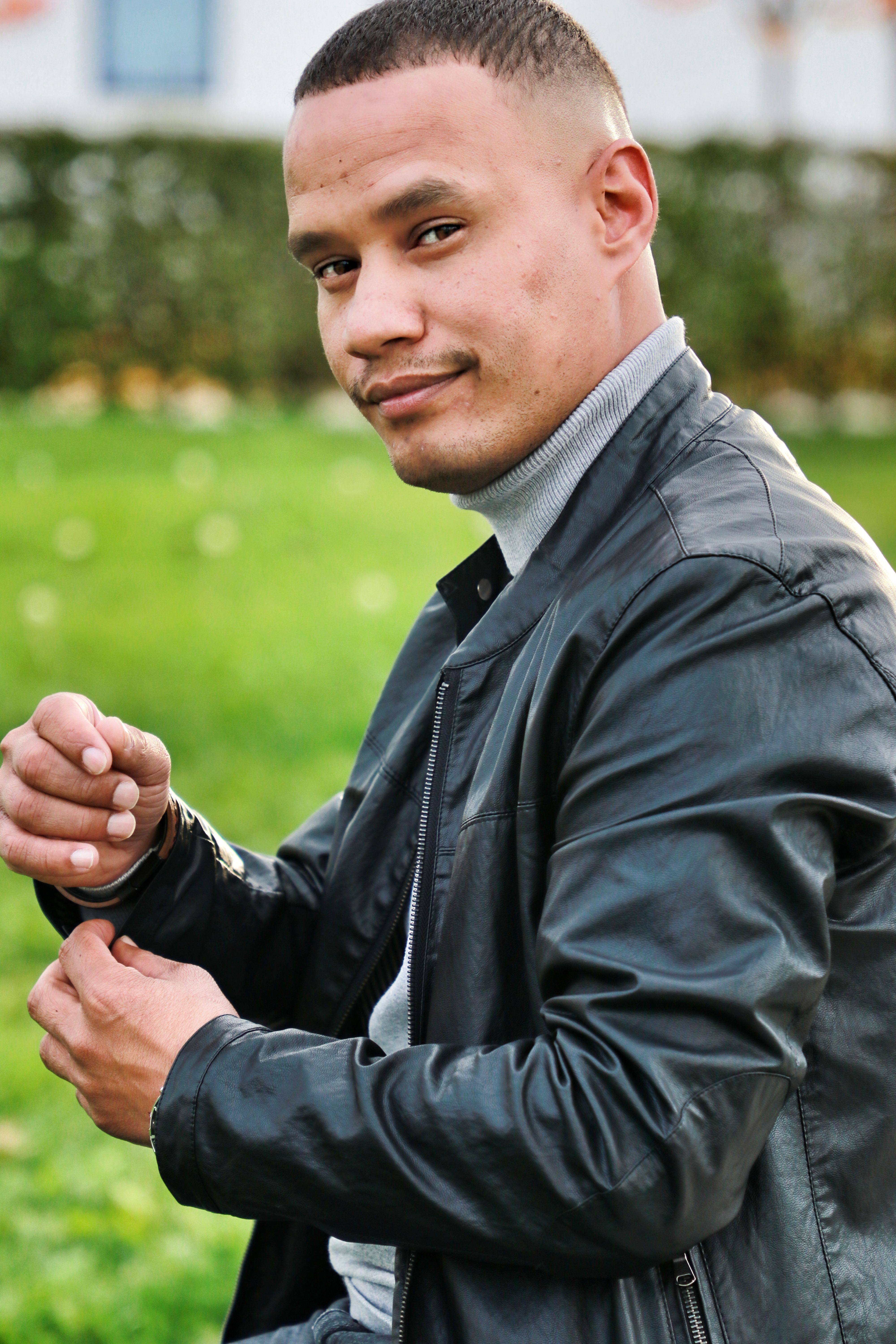 Smiling man in a black leather jacket outdoors in Villingen-Schwenningen, Germany.