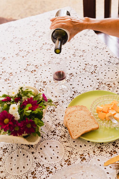 A Person Pouring Red Wine in a Glass