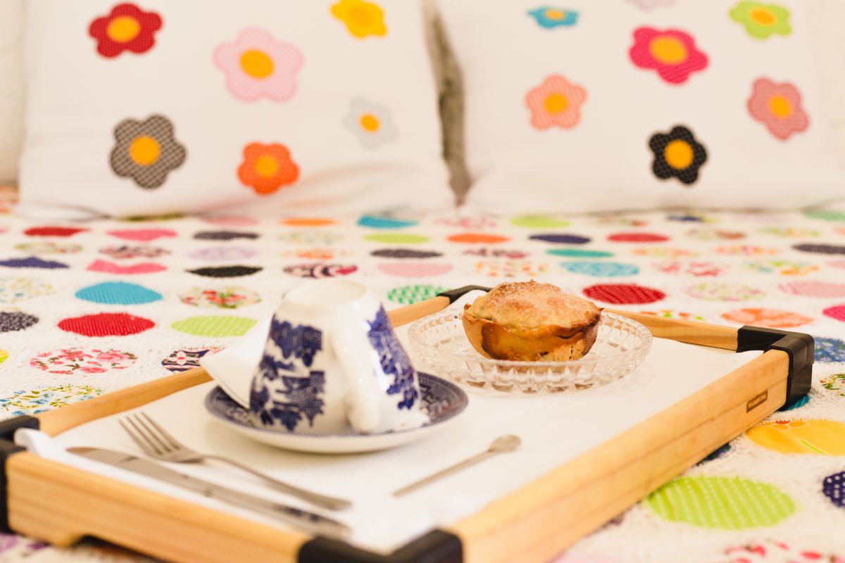 Breakfast tray on a flower-patterned quilt
