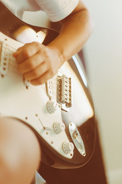 Free Close-up shot of a person strumming an electric guitar, emphasizing music and skill. Stock Photo