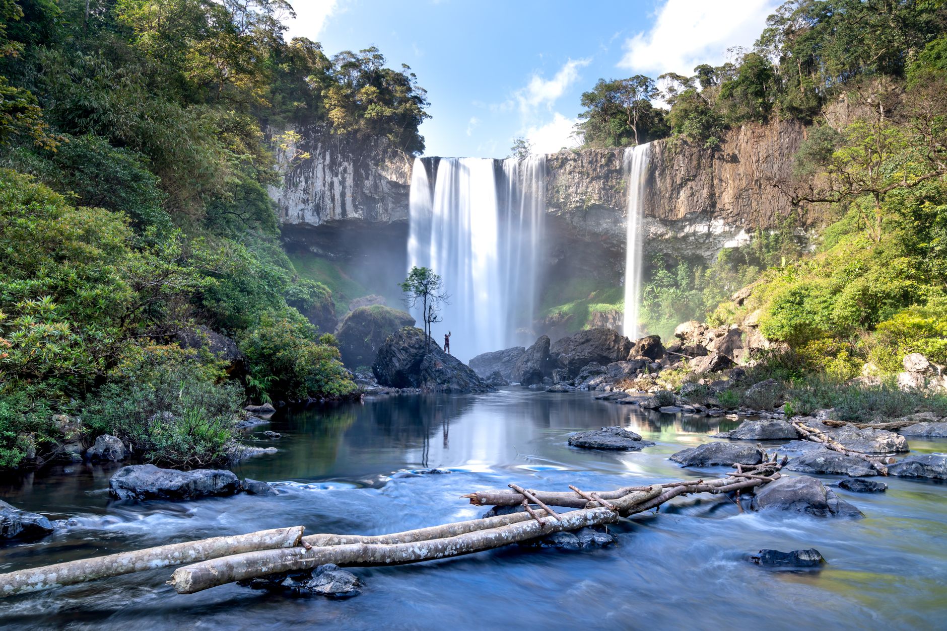 Stunning view of Kon Chu Rang Waterfall amidst lush greenery in Vietnam's Gia Lai province.