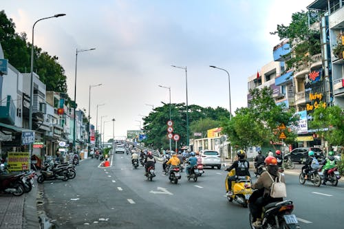 People Riding Motorcycles on Road