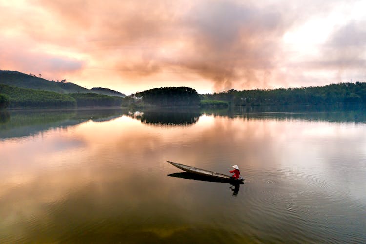 Person Riding On Boat On Lake