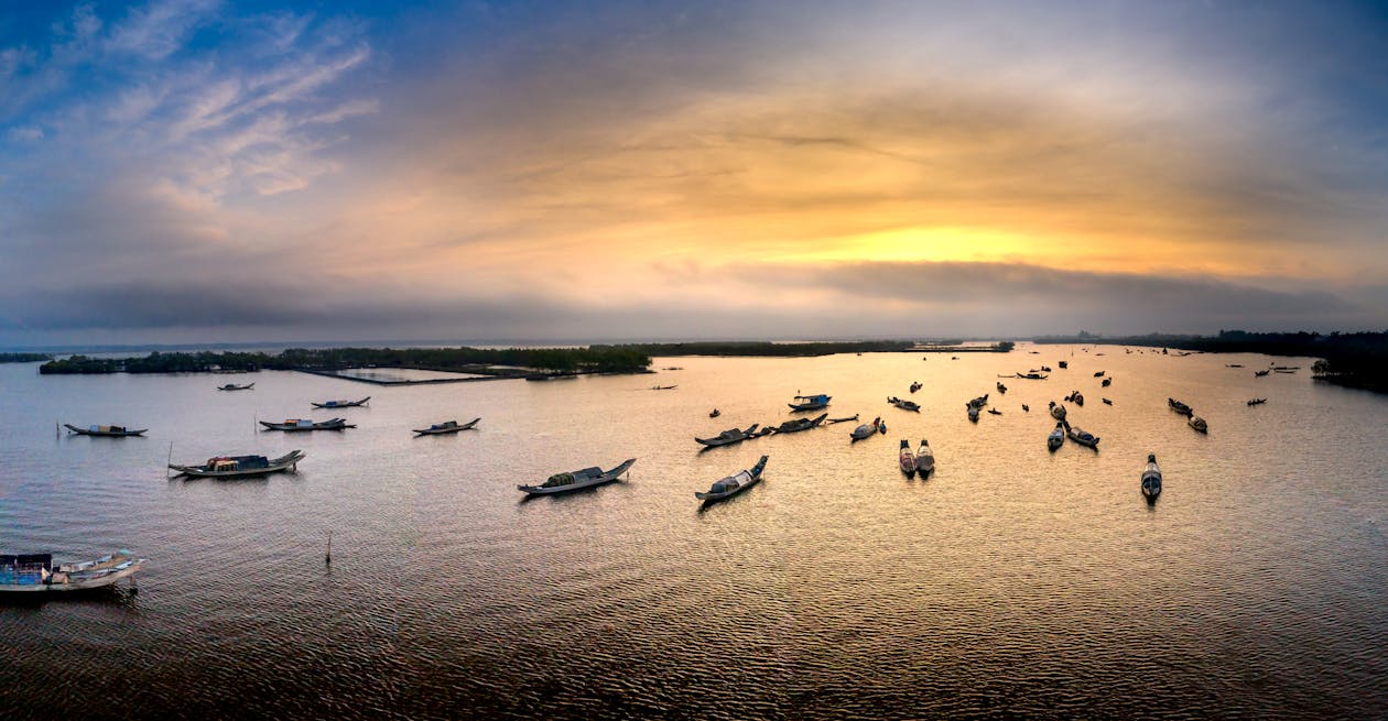 Boats on Water During Sunset