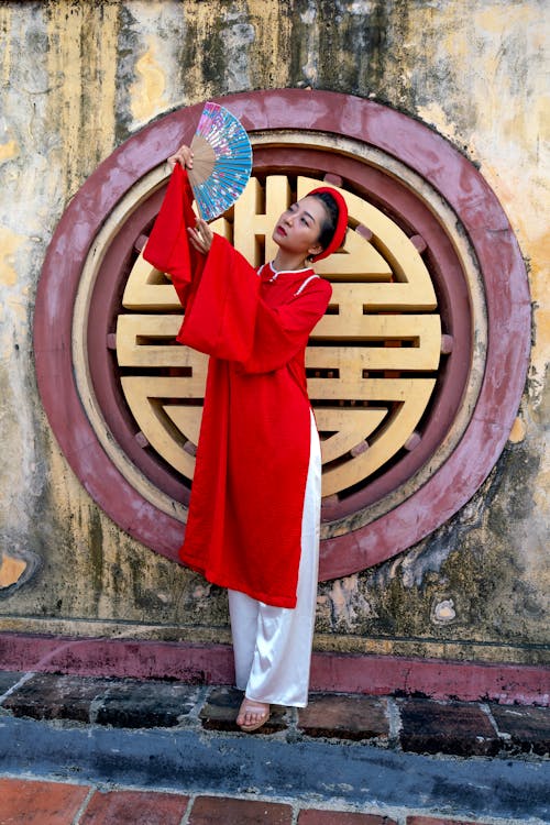 Woman in Red Dress Raising Her Hand Fan
