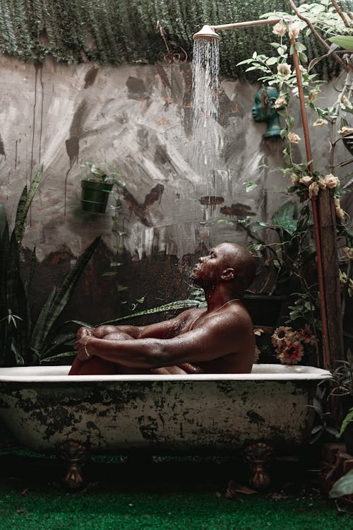Shirtless Man Sitting in Bath 