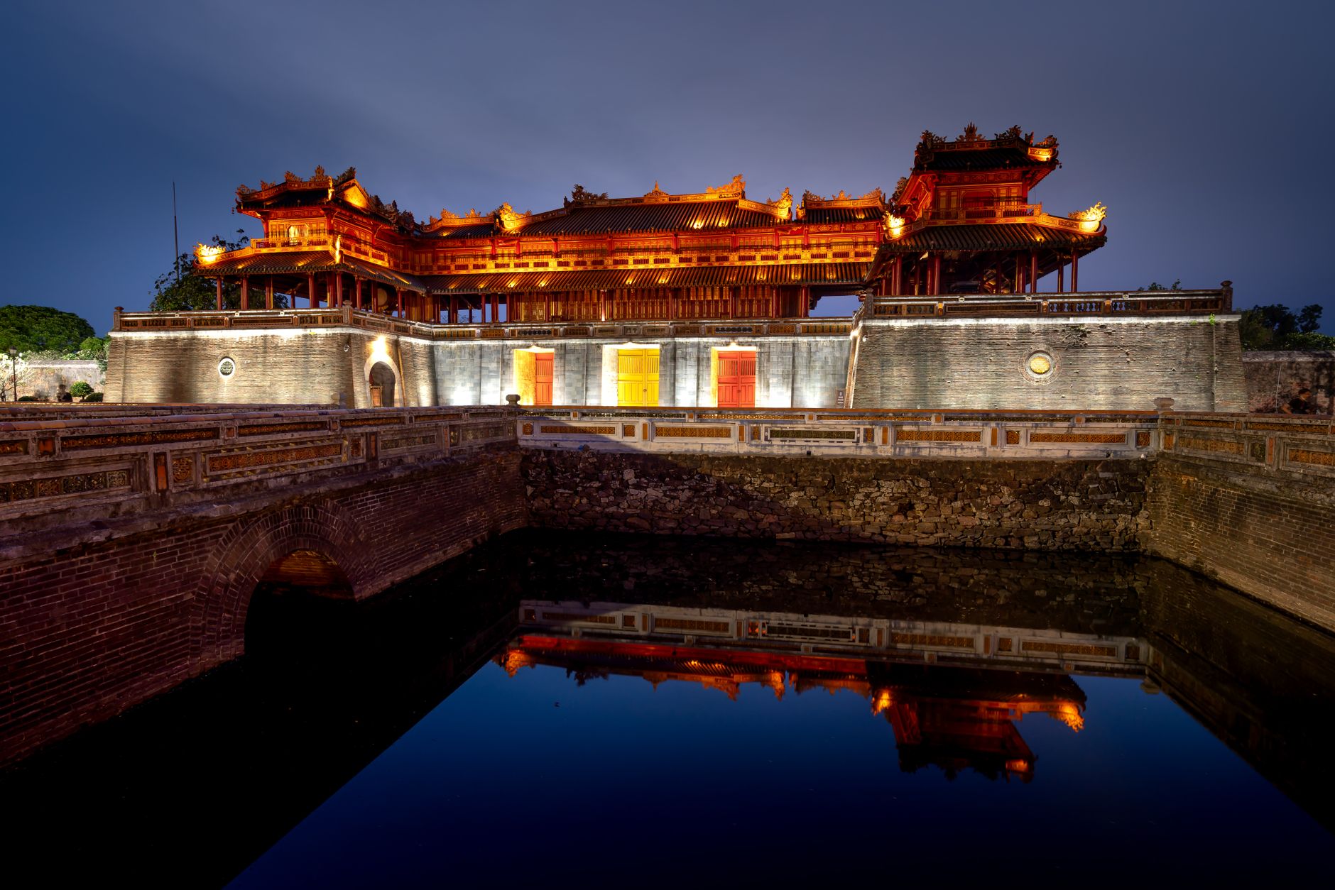 Stunning view of the Imperial City of Hue, Vietnam, reflected in calm waters at dusk.