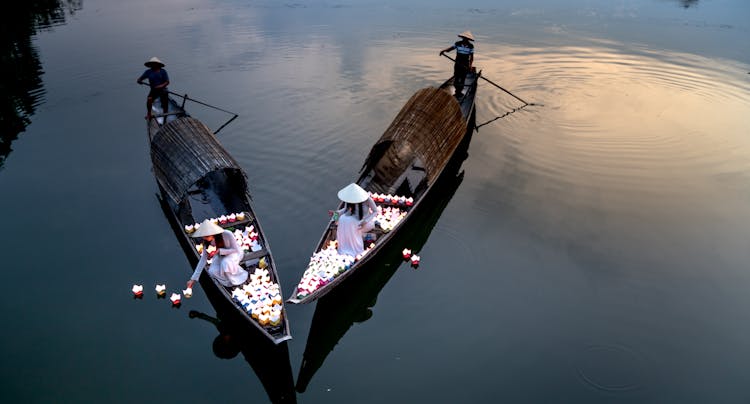 High Angle Shot Of Women On Boats Decorating Pond With Lanterns