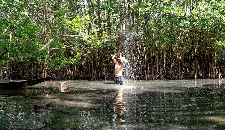 Man Catching Fish In A River