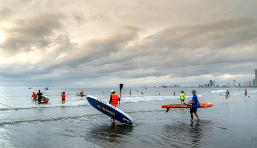 People with SUP Boards at Seashore