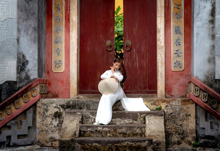 A Woman Sitting On Steps