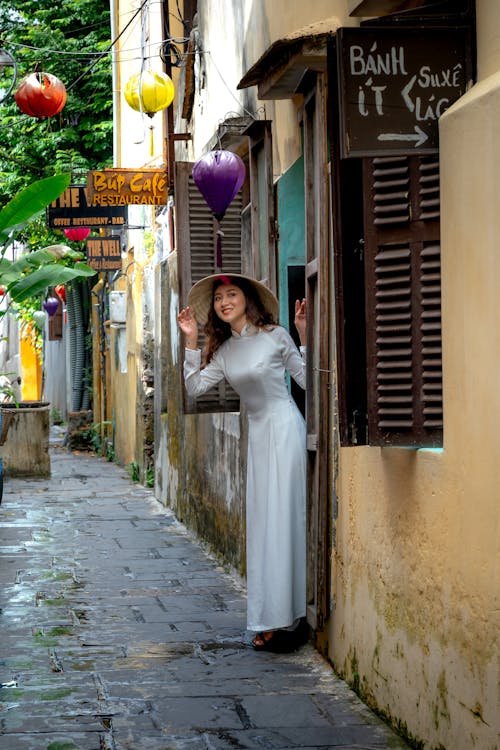 Free Photograph of a Woman in a Dress Wearing an Asian Conical Hat Stock Photo