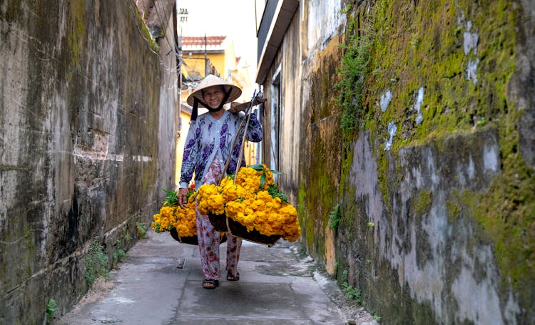 A Woman Carrying Marigold Flowers