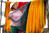 Smiling Woman Looking at Fishing Net