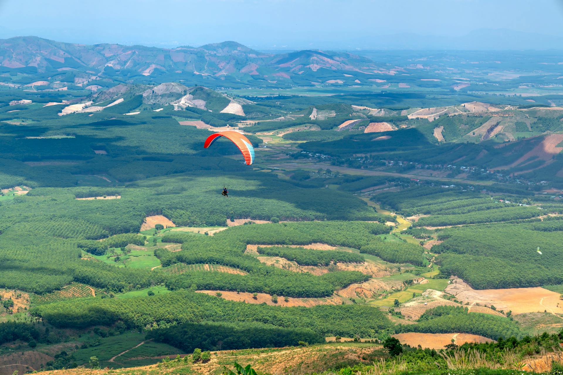 Red and White Parachute over Green Mountains