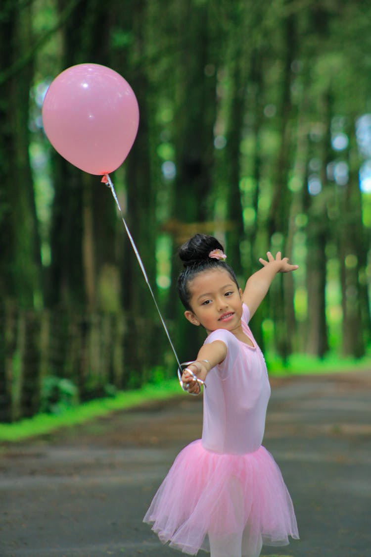 A Girl Holding Pink Balloon