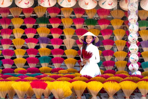 Market traders arranging colourful goods at an open-air market — photo by Quang Nguyen Vinh on Pexels