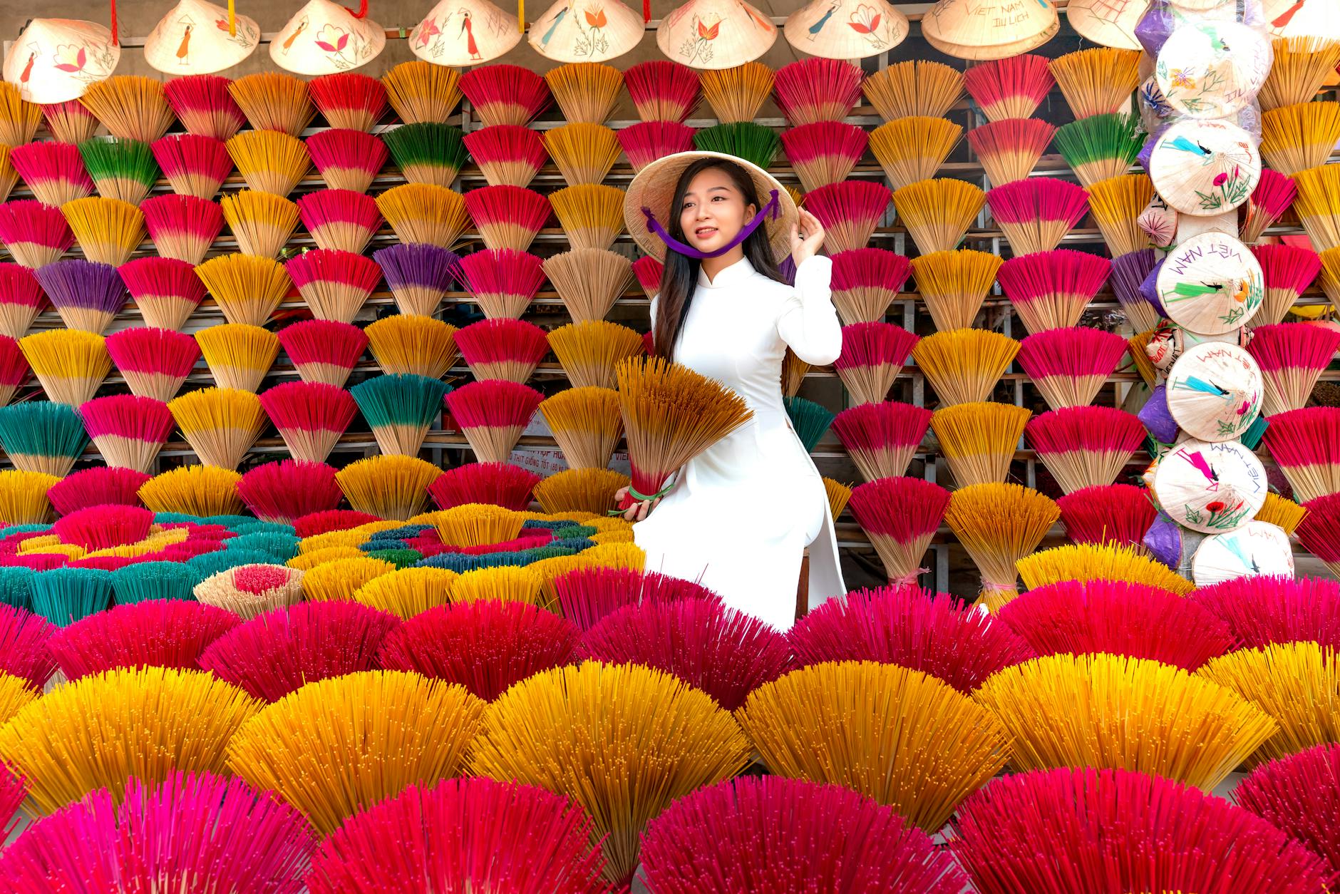 https://www.pexels.com/photo/woman-in-white-dress-holding-a-bunch-of-incense-14022447/