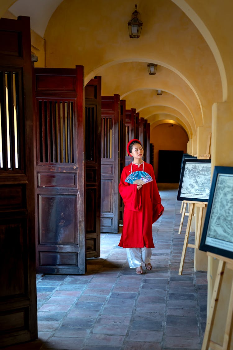 Woman Walking With A Paper Fan