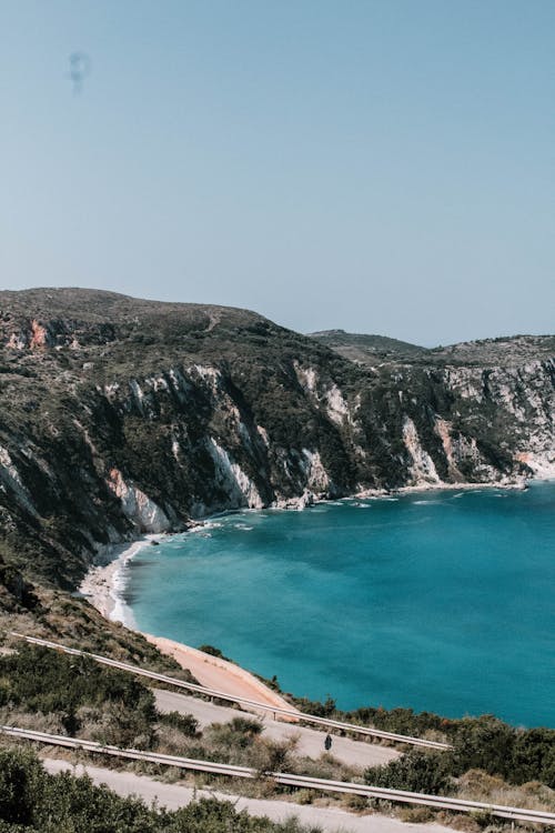 Body Of Water Beside Mountain