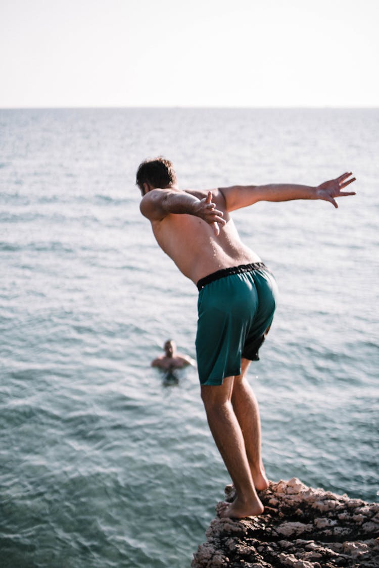 Man On Cliff About To Jump