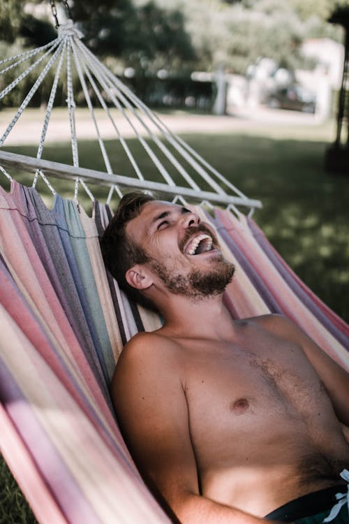 Free Laughing Man Laying On Hammock Stock Photo