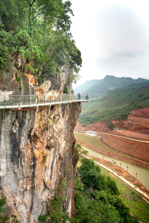 People on a Bridge Mounted on the  Cliffside