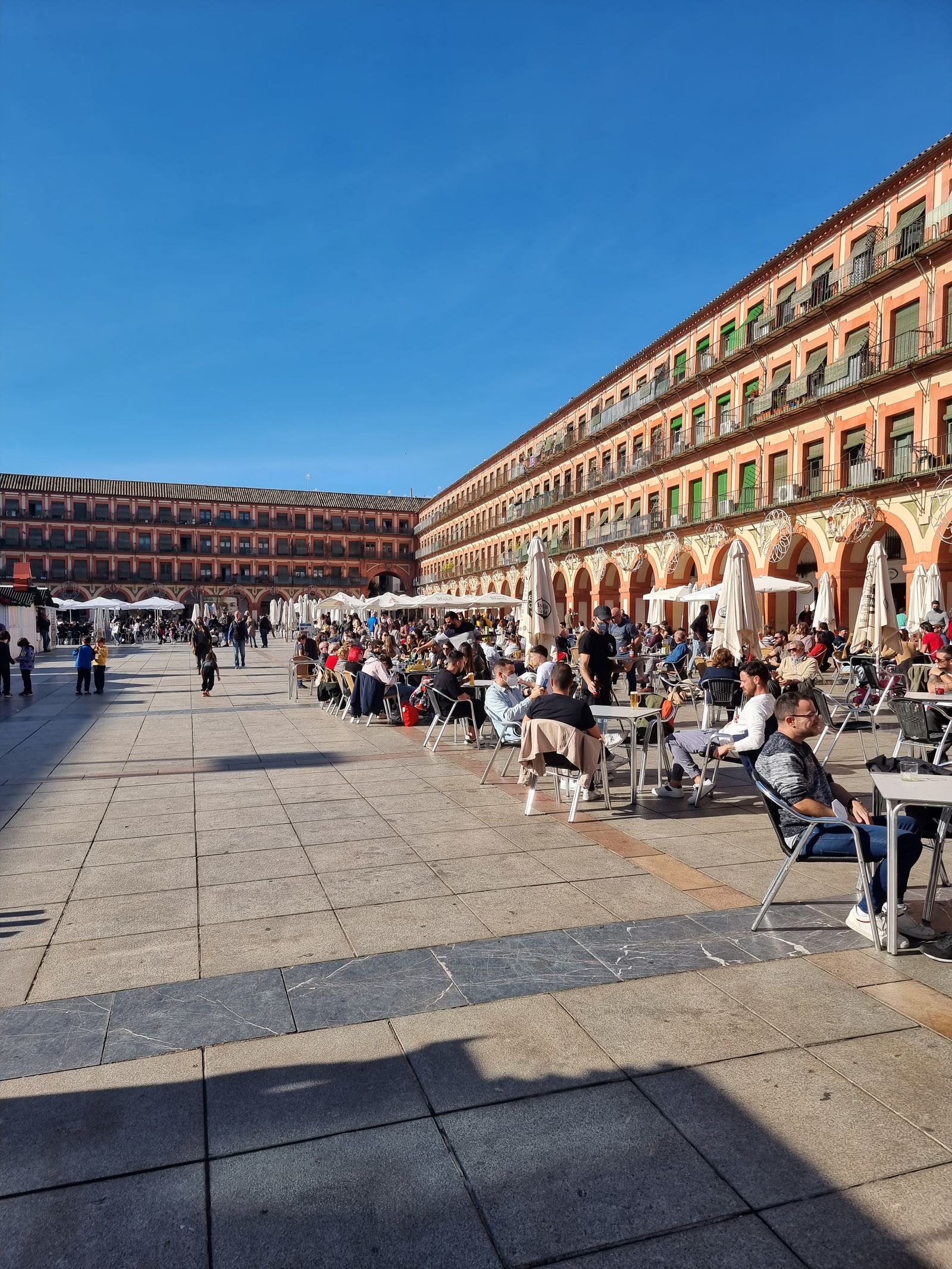 People sharing a public square in Córdoba