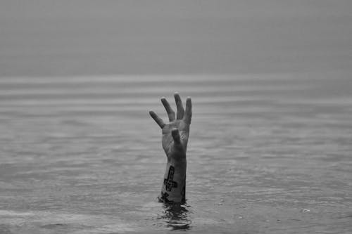 Grayscale Photo of a Person in the Water