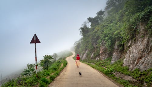Person Walking on a Narrow Road