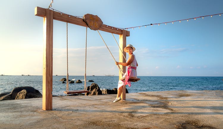 Woman On A Swing Near The Sea